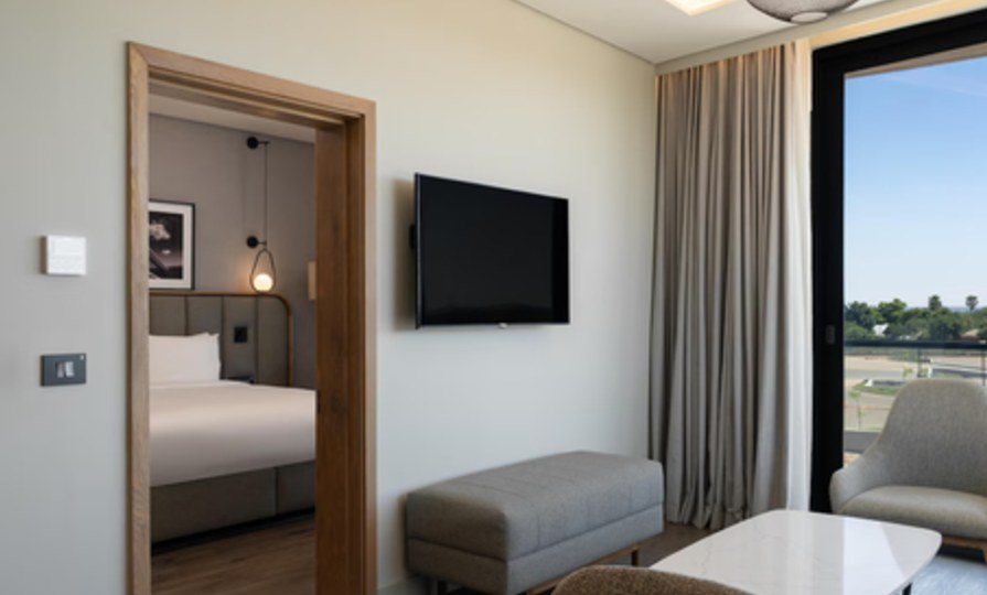 Connecting suite with bedroom joinery beyond