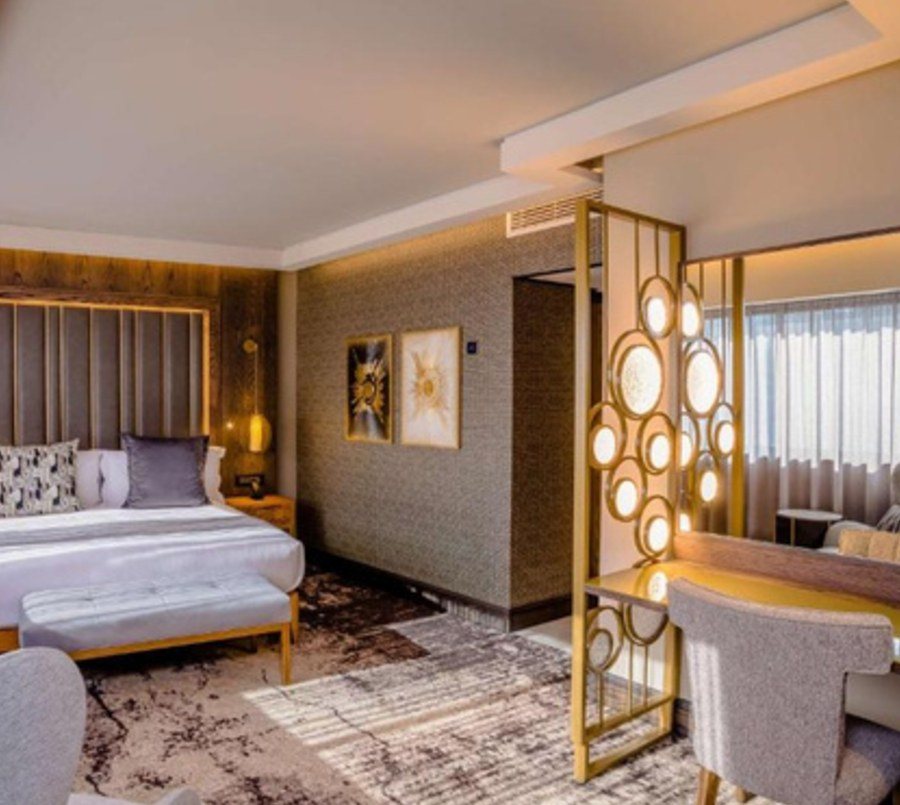 Suite entrance with brass screen and bedroom beyond
