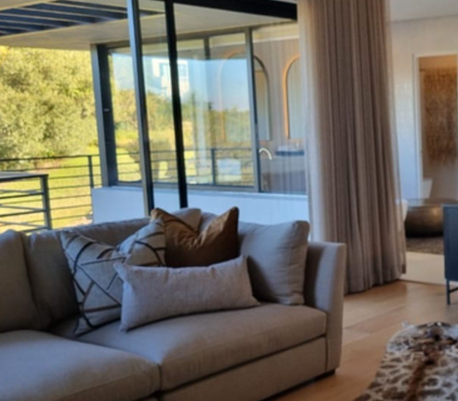 Lounge seating framed by the garden glazing
